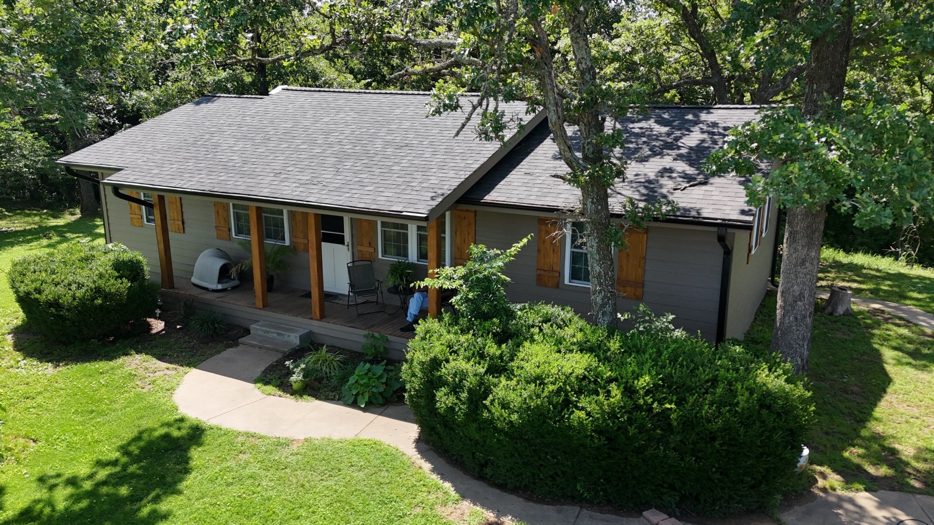 Apollo's completed full exterior restoration with new siding, roofing, shutters, and porch posts